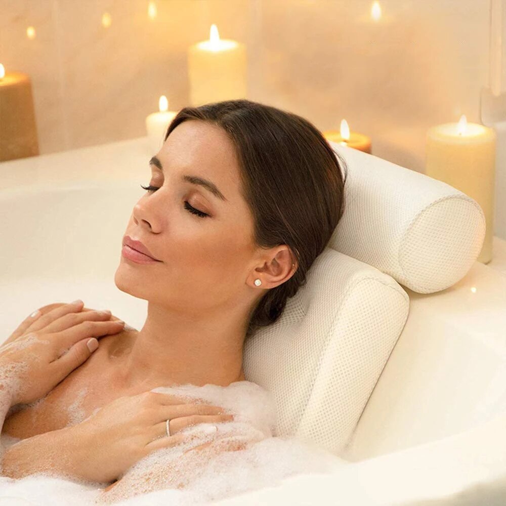 Close-up of a woman resting comfortably on a bath pillow surrounded by candles