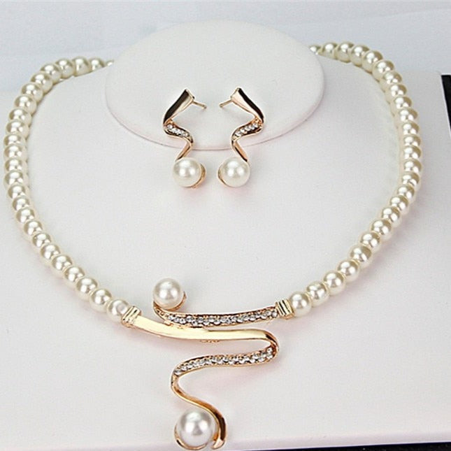 Women's pearl necklace and matching earrings set on display