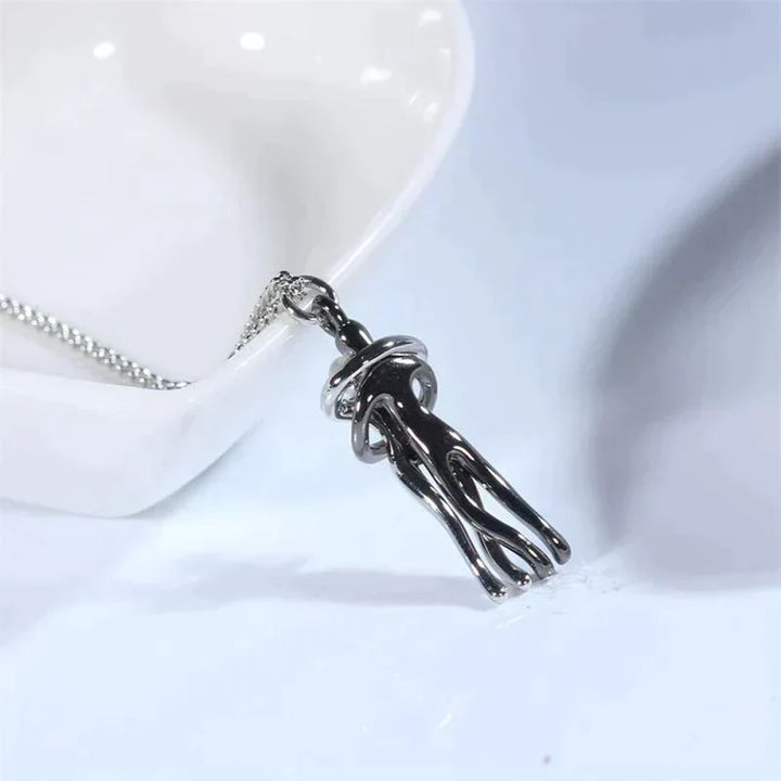 Side profile of the unisex silver jewelry piece highlighting the pendant detail