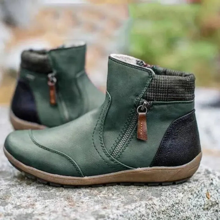 Women's orthopedic waterproof ankle boots in black, side profile view showing arch support