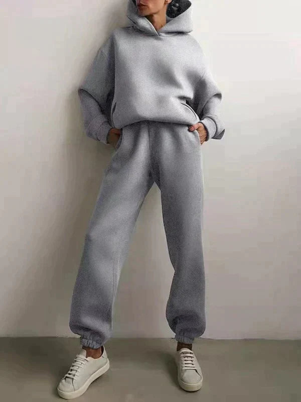 Women's two-piece hooded jogging set in a neutral tone, showcasing the sweatshirt and pants