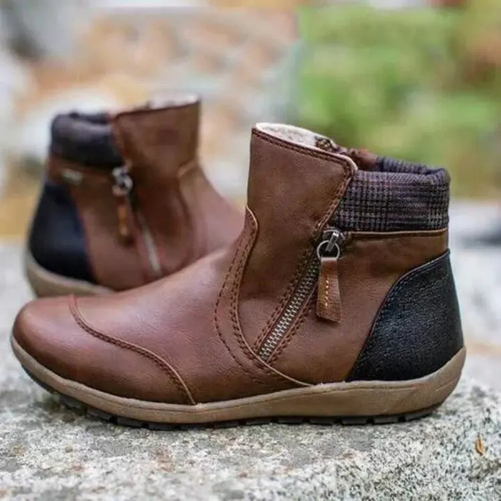 Brown orthopedic waterproof ankle boot with side zipper on stone background