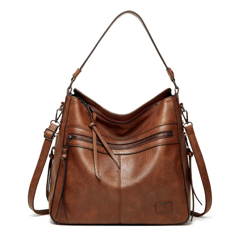 Brown luxury shoulder bag featuring multiple zippered pockets and sturdy handles