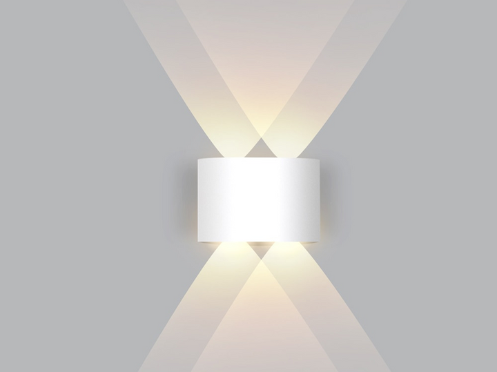 Illuminated dual beam wall light highlighting textured accent wallpaper indoors.