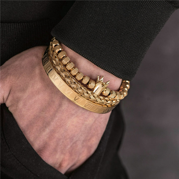 Set of mens luxury gold and silver stackable bracelets on display
