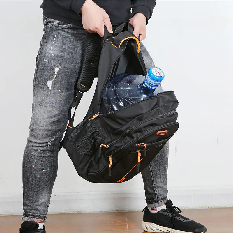 Person packing a large water jug inside the spacious main compartment of the black daypack.