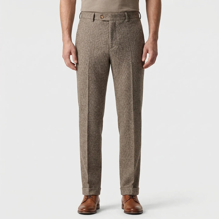 Tailored slim fit herringbone trousers for men showing textured fabric close-up