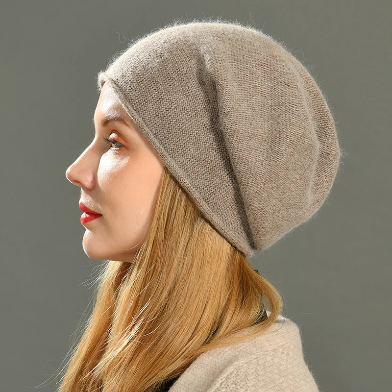 Woman wearing a soft beige knit beanie hat showcasing the relaxed slouchy fit from the side profile