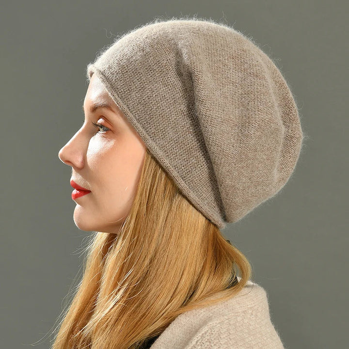 Woman wearing a soft beige knit beanie hat showcasing the relaxed slouchy fit from the side profile