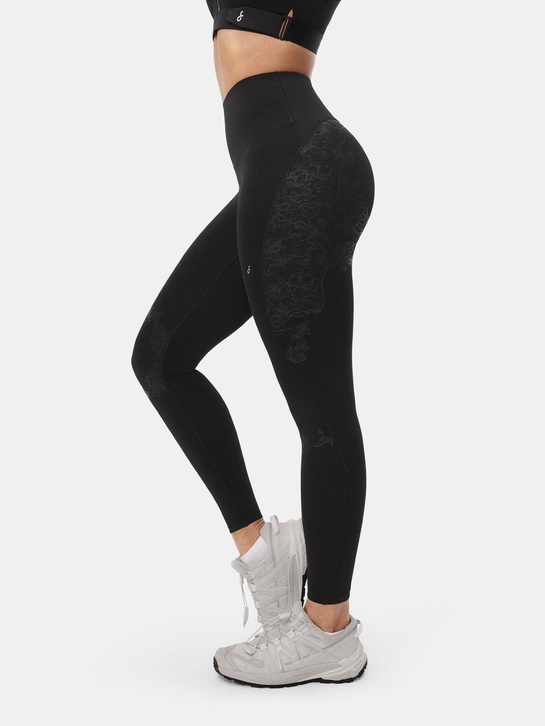 Side profile of woman wearing black high-waisted sculpting gym leggings