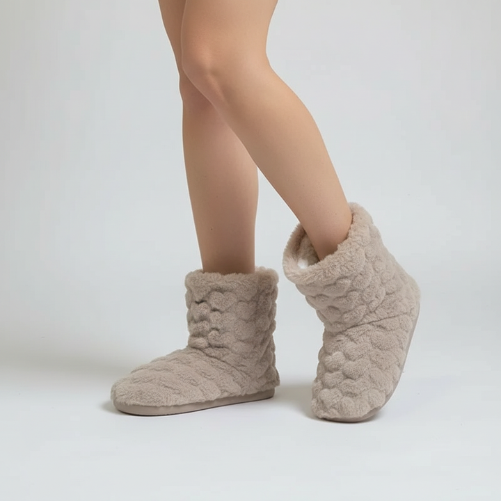Side view of fluffy beige indoor slipper boots showcased against a plain background