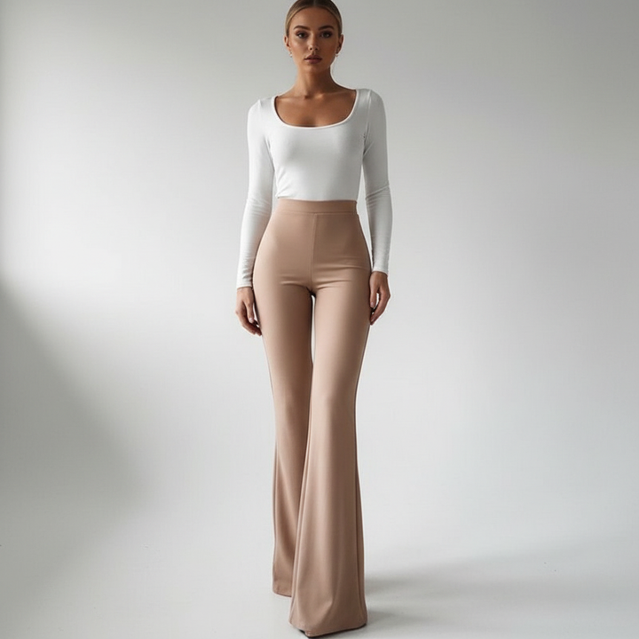 Full-length view of woman in high-waisted flared trousers in neutral tone