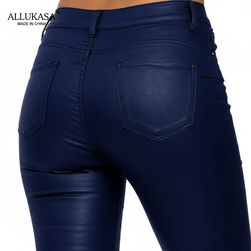 Close-up of the back pockets and high waistband of blue trousers.