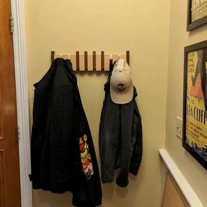 Wooden wall hook mounted in modern entryway for hanging coats
