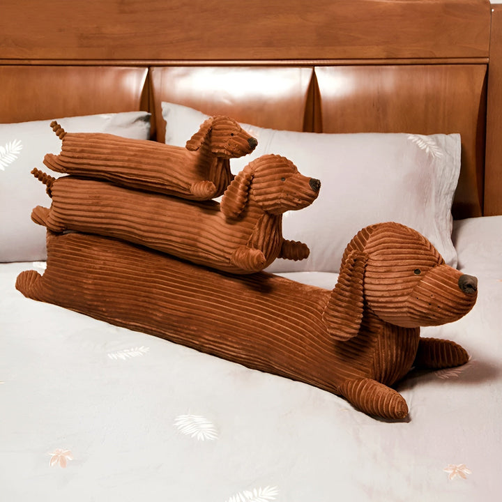 Stacked brown dachshund plush pillows in three different sizes
