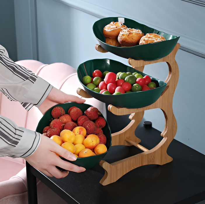 Green multi-tier fruit stand holding fresh pastries and produce
