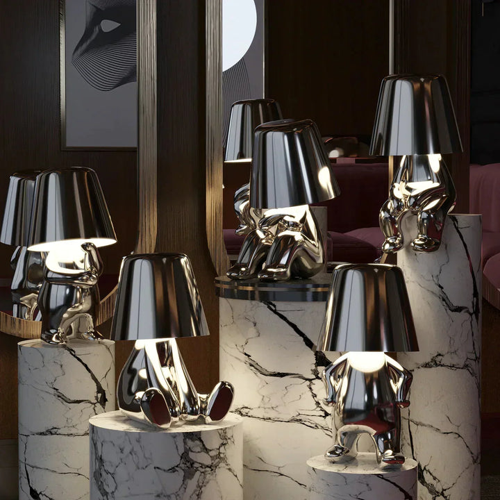 Silver artistic mood lamps glowing on marble pedestals in a luxury interior