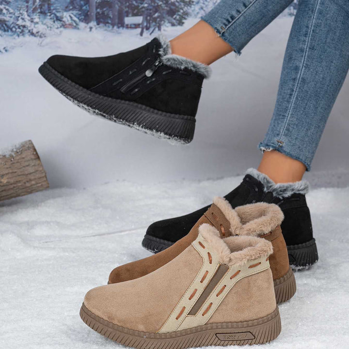 Three pairs of women's winter ankle boots in black, brown, and khaki displayed outdoors on snow.