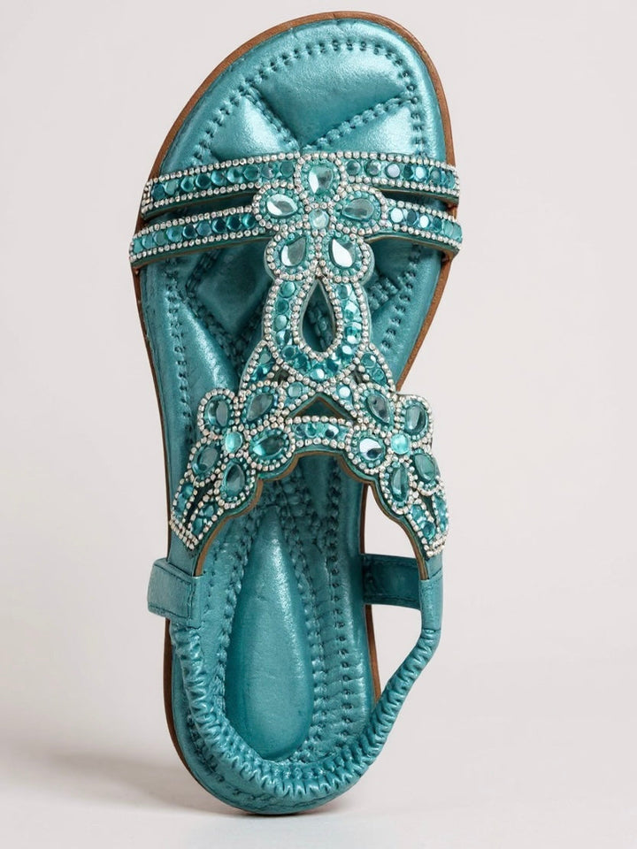 Pair of sparkling embellished flat sandals styled for summer wear