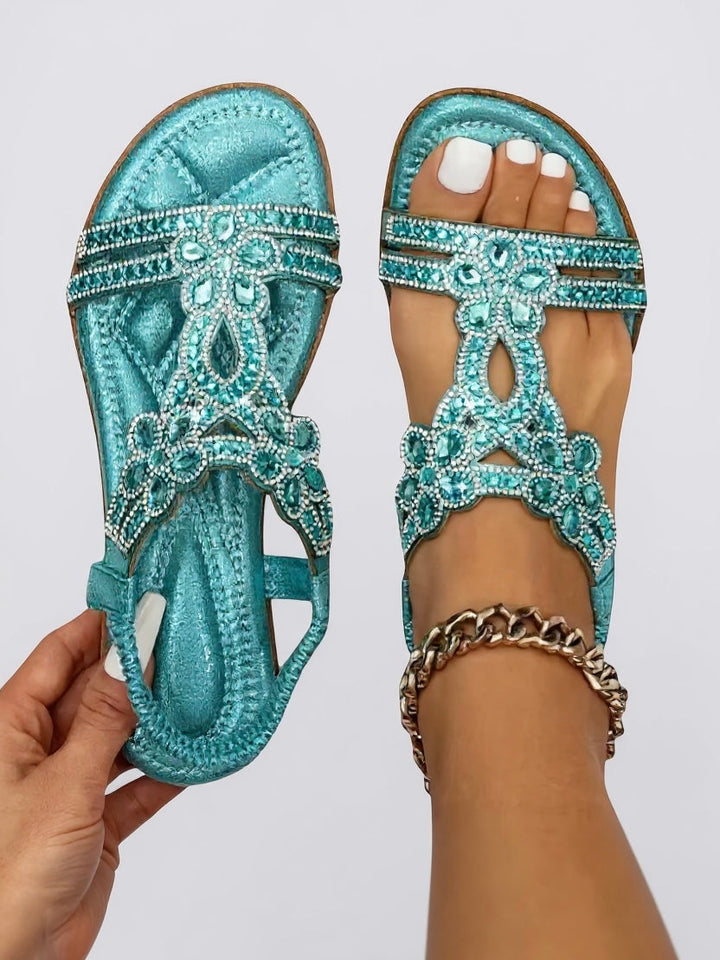 Side profile of sparkly embellished flat sandals for women