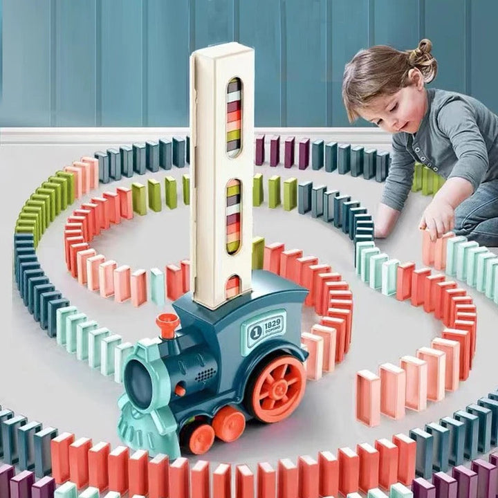 Child playing with colorful Domino Train building set