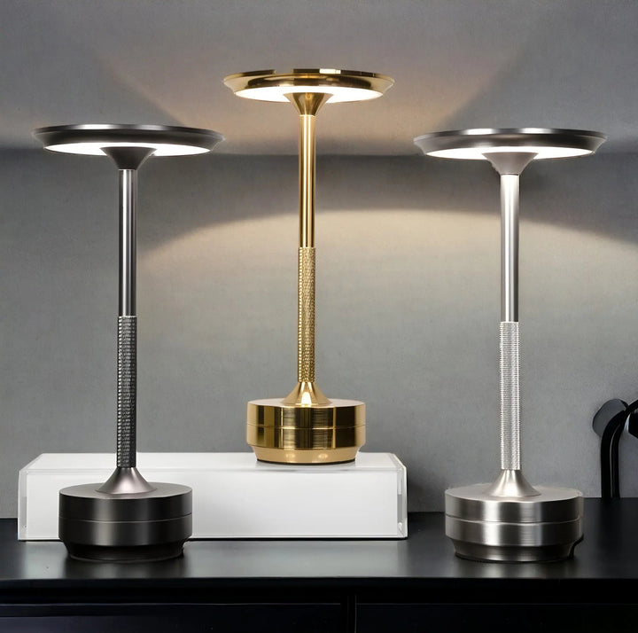 Black, Gold, and Gray cordless touch table lamps displayed side by side on a dark surface.