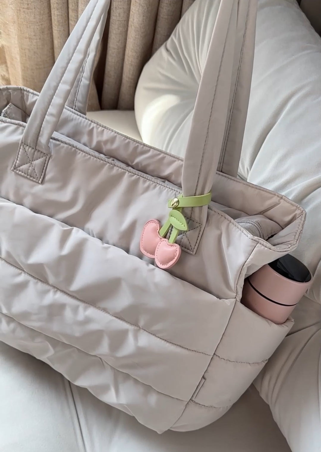 Stylish women's puffer laptop backpack in neutral tone for everyday travel and work