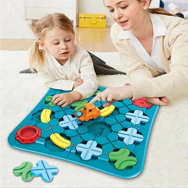Child and mother playing with the magnetic track set on a rug