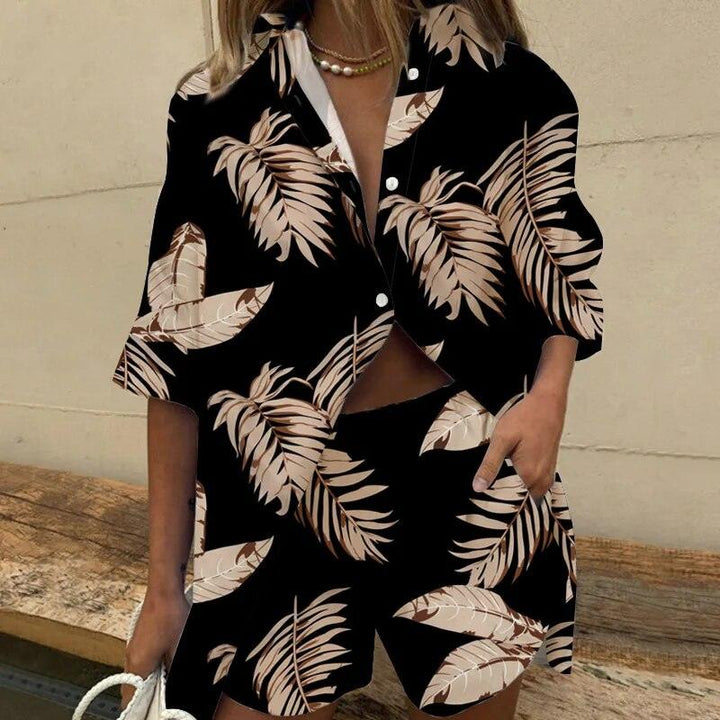 Woman wearing black leaf patterned blouse and shorts