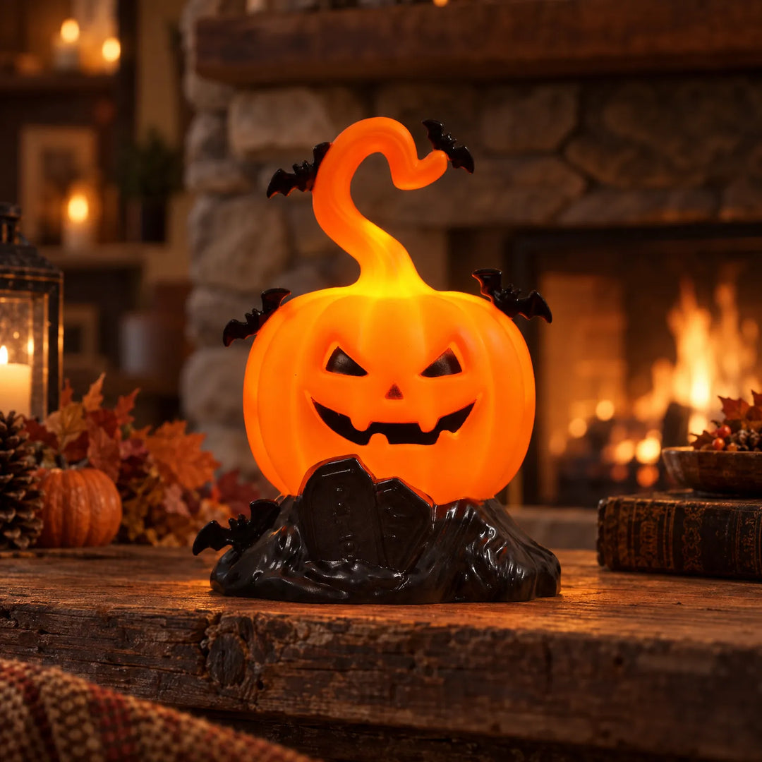 Illuminated jack-o-lantern pumpkin light glowing on a rustic wooden table