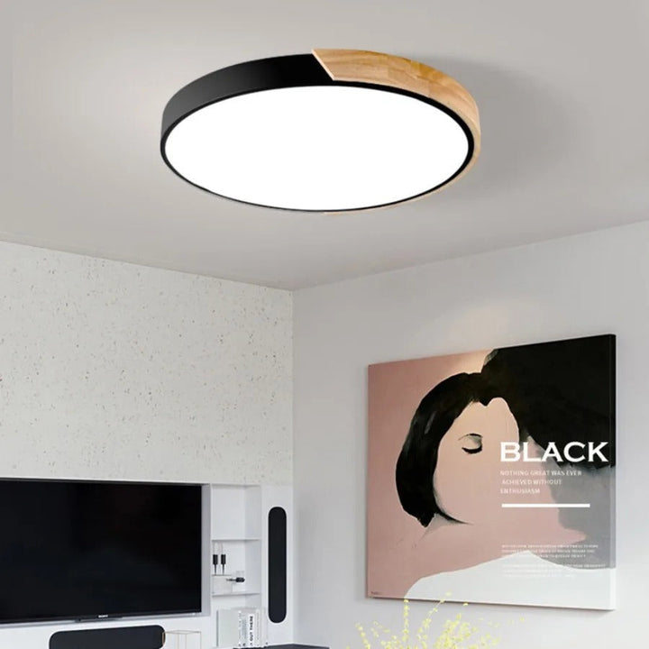 Black Nordic Macaron round wooden ceiling lamp mounted on a modern living room ceiling