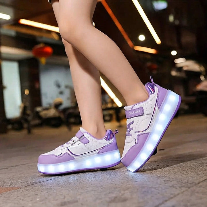 Child wearing purple and white LED light-up roller shoes outdoors at night