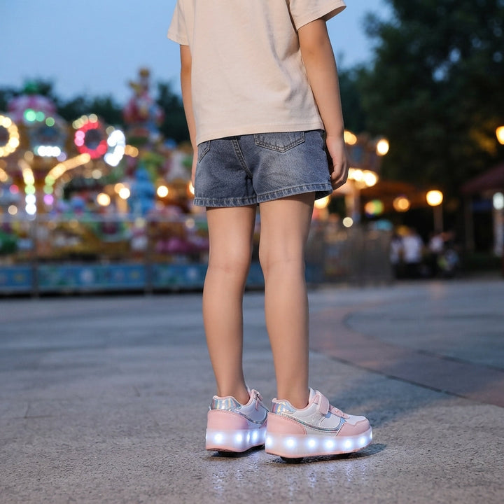 Child wearing pink and white light-up roller shoes standing outside