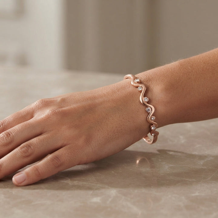 Close-up view of the minimalist copper bracelet featuring a unique wave design