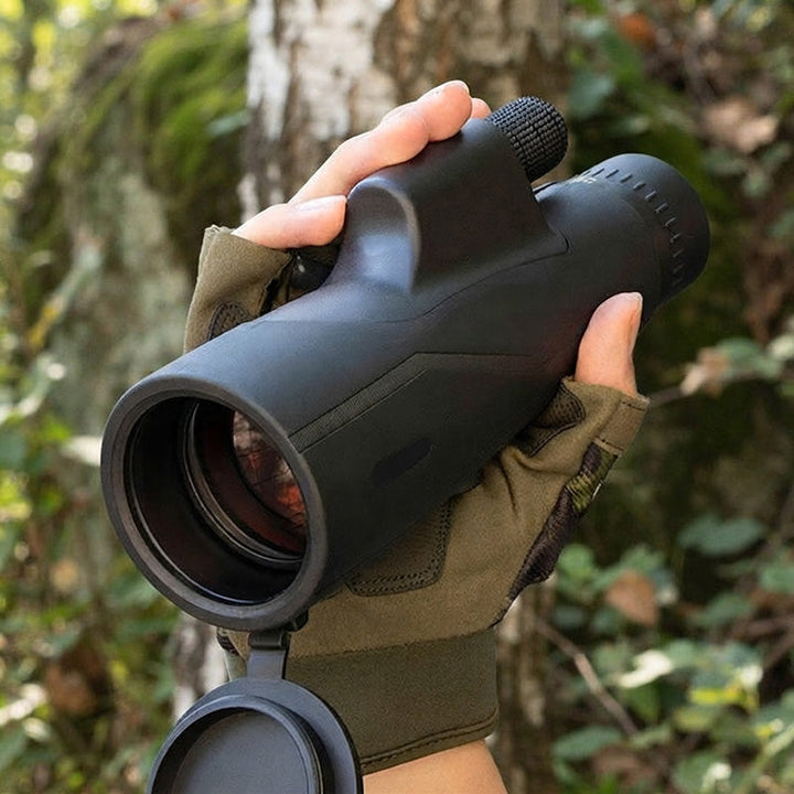 Person holding portable astronomy telescope outdoors
