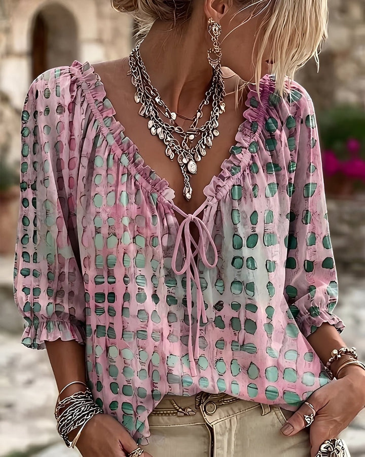 Side view of women's fashionable polka-dot blouse with V-neckline