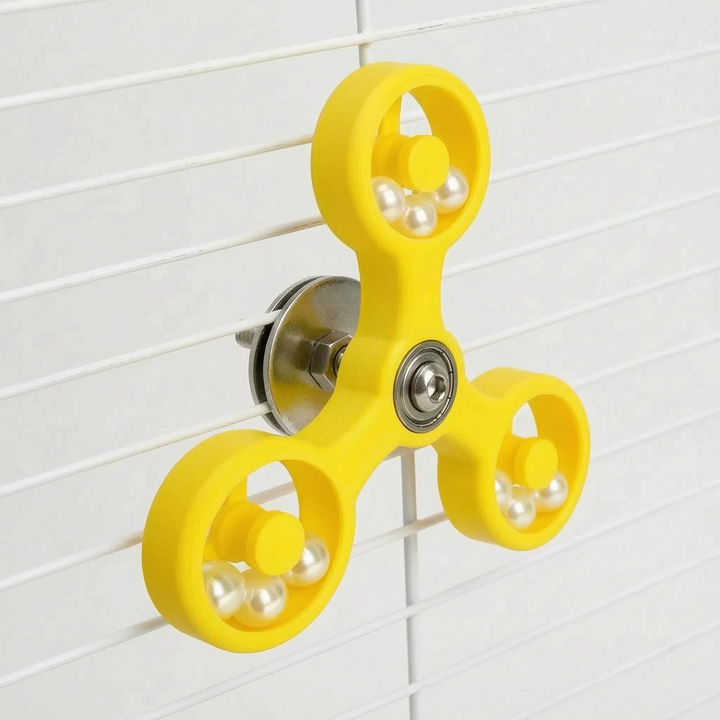 Close-up of bird enrichment toy showing multi-directional rotation