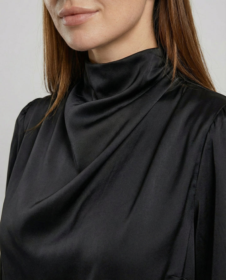 Side profile of women's long-sleeve midi dress showcasing evening wear silhouette