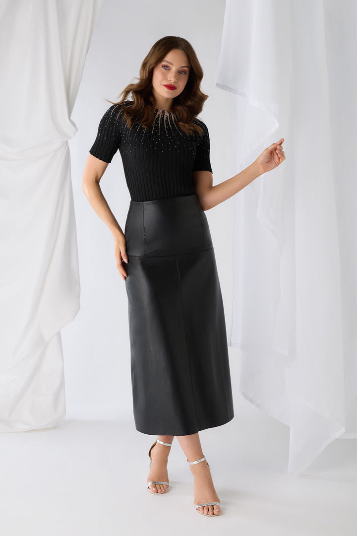 Woman posing in black high waist midi skirt and embellished top