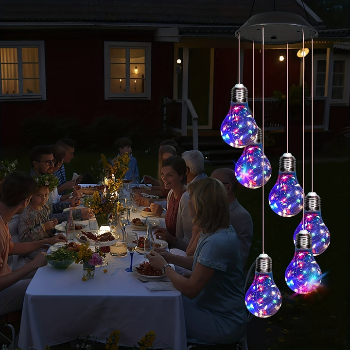 Close up of solar powered light bulb wind chime for garden patio decor