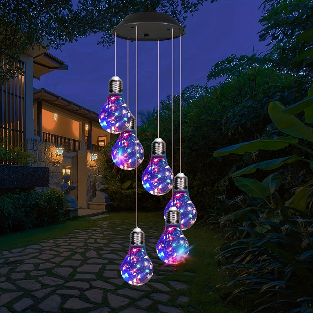 Decorative outdoor solar light bulb wind chime glowing in vibrant colors