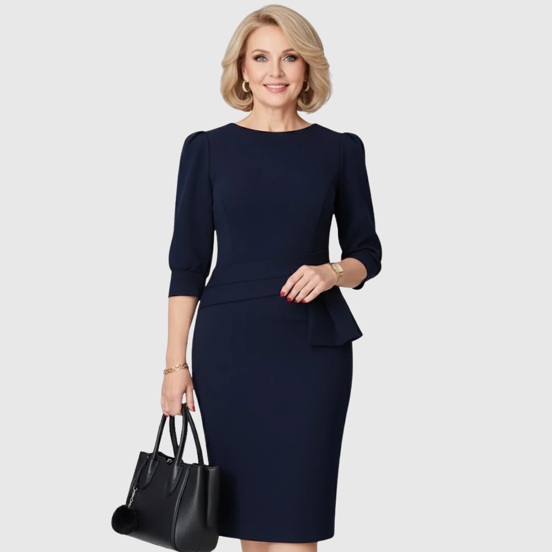Model wearing a dark blue ruffle midi dress with three-quarter sleeves and a black handbag