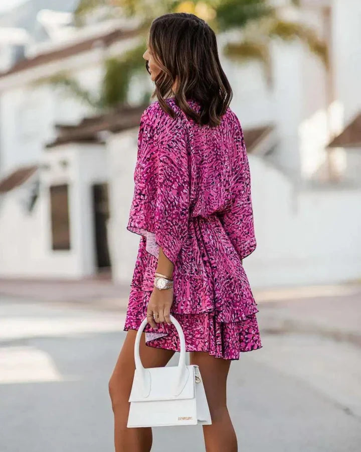Side and back view of woman wearing pink summer dress outdoors