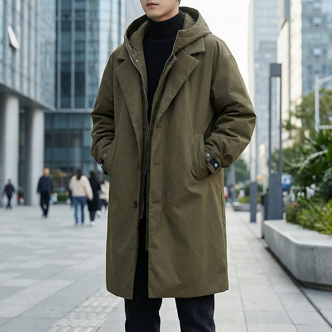 Man wearing a green winter parka trench coat outdoors in the city