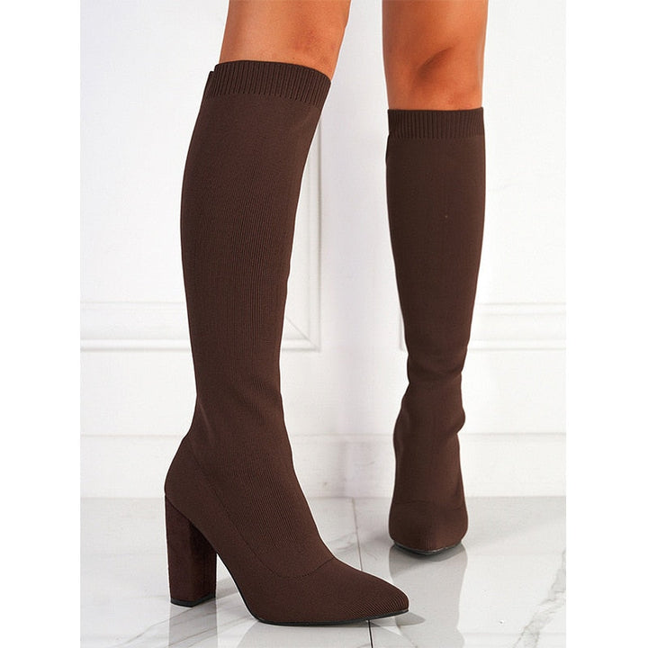 Detailed shot of sole and low block heel on stylish womens knee-high boots
