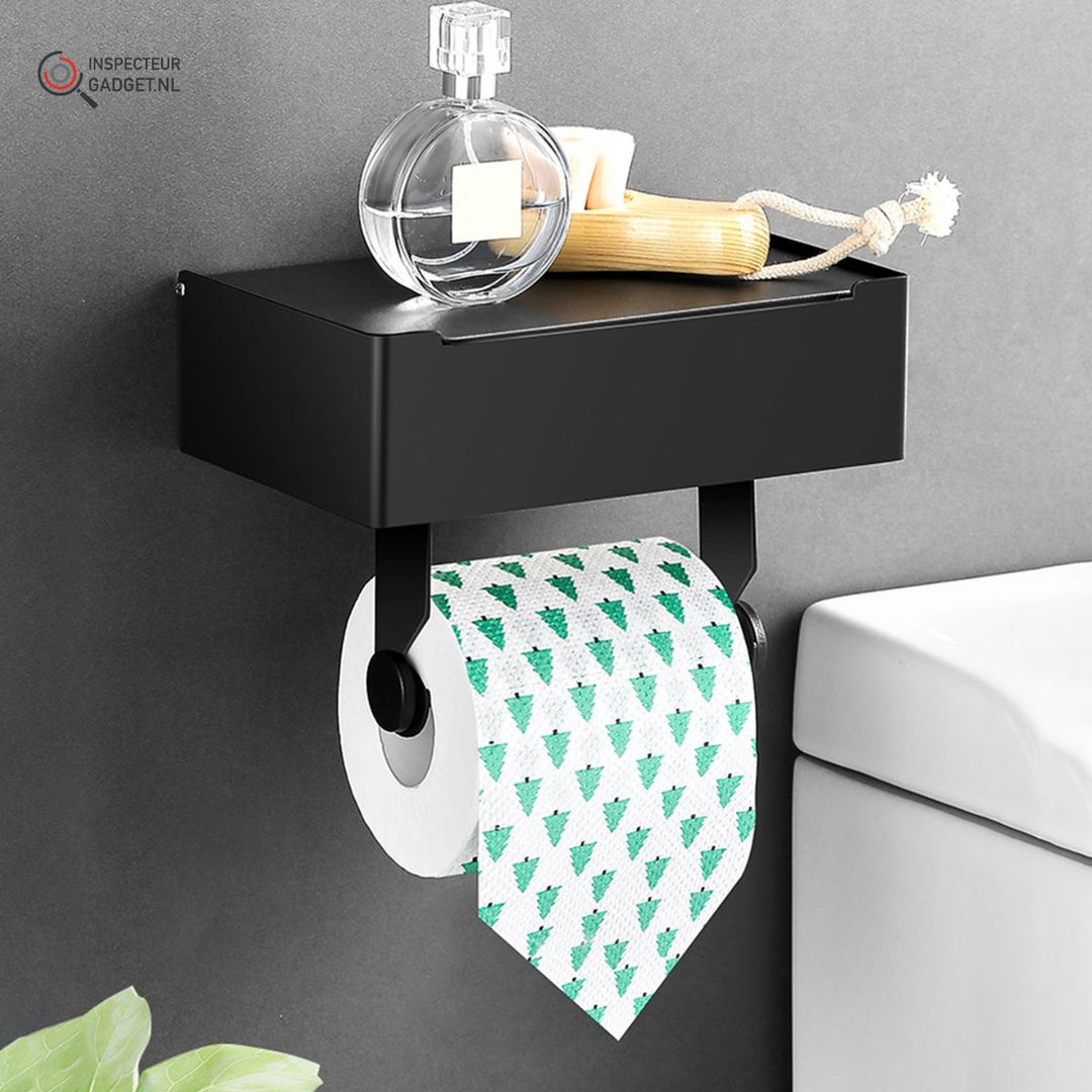 Wall-mounted black toilet roll holder featuring a top shelf with a perfume bottle and brush