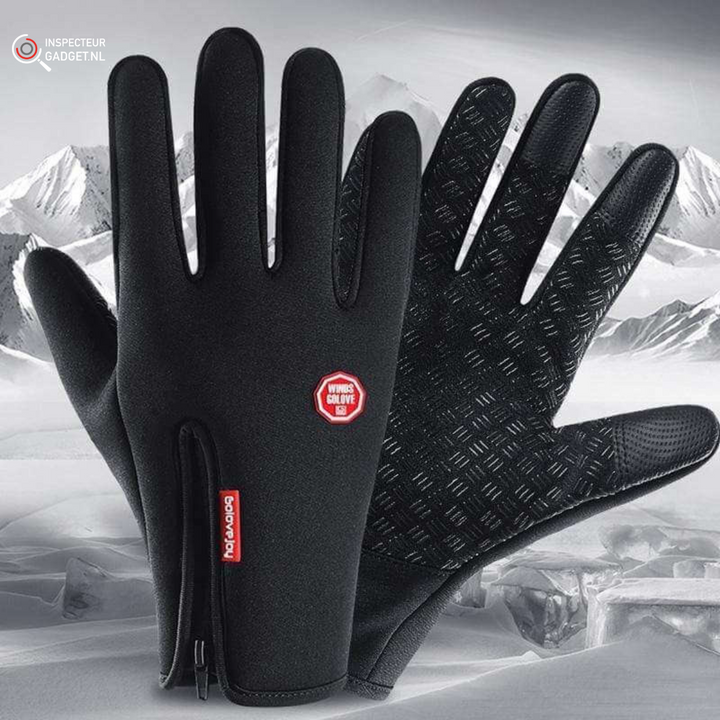 Black waterproof thermal winter gloves with zipper detail against a snowy mountain background