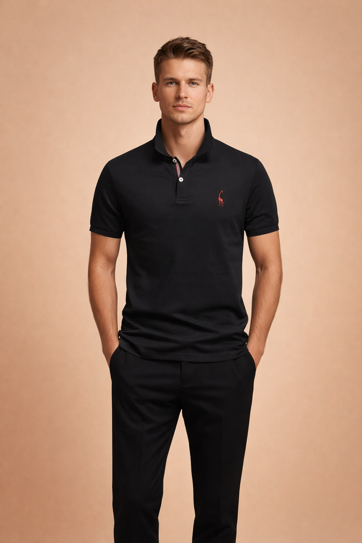 Man wearing a black classic polo shirt with matching black trousers in a neutral studio environment.