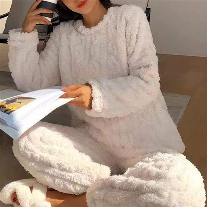 Woman sitting down and relaxing in soft white pyjamas holding a book