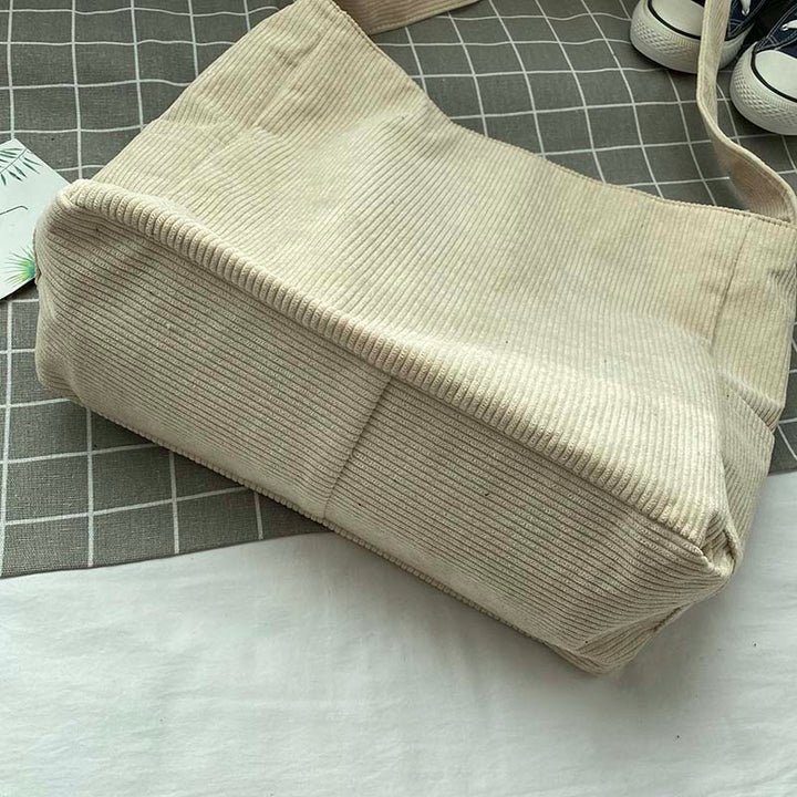 Interior view of womens multi pocket corduroy handbag